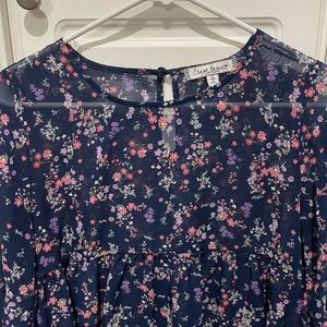 Women’s small sheer blouse long sleeve with ruffles on sleeves.